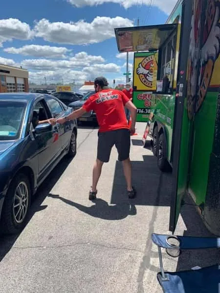 Carrubba's crew member serving food curbside at a pop-up