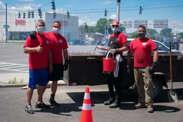 The Carrubba's pit crew cooking chicken BBQ at a community fundraiser